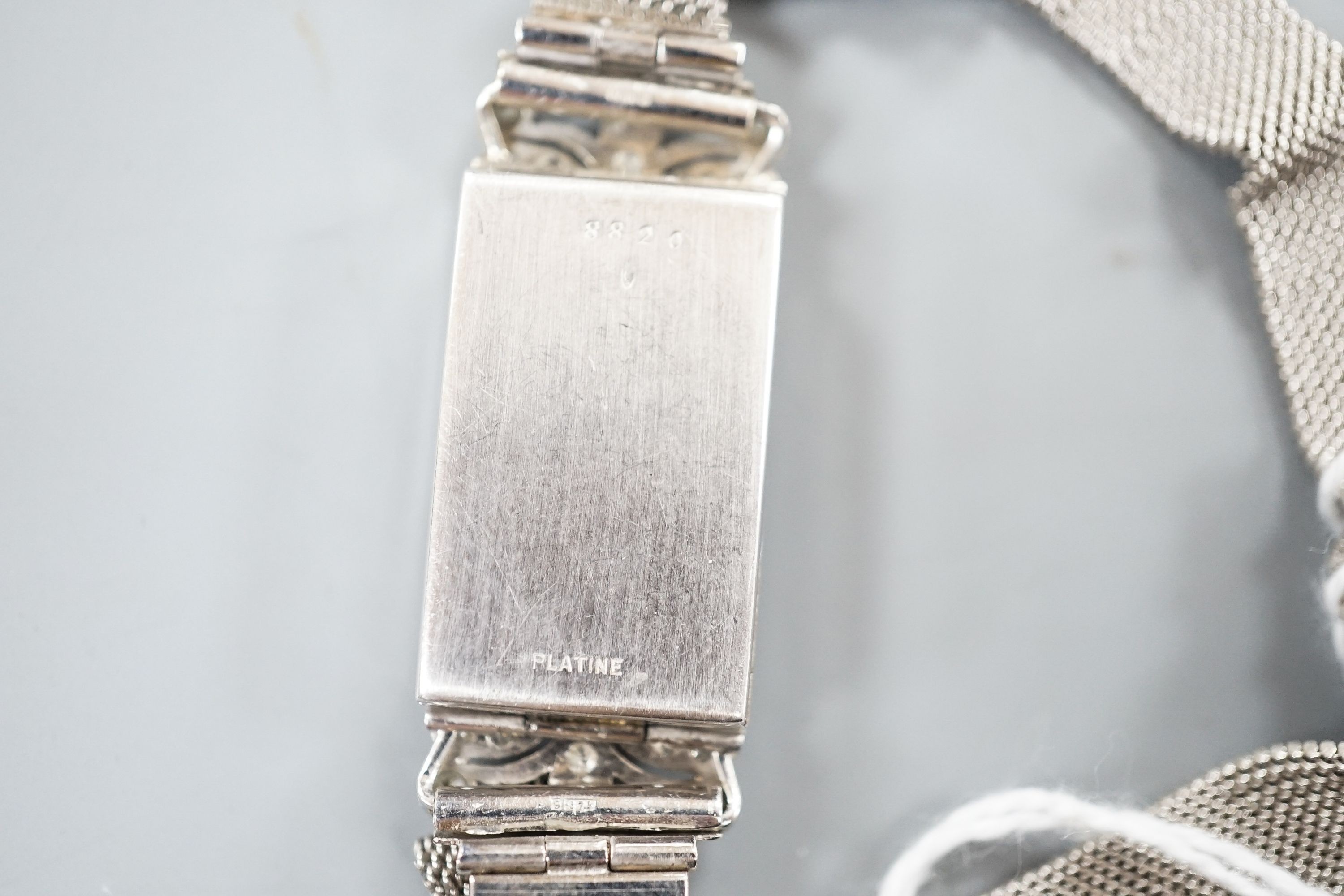 A lady's early 1970's white metal and diamond set cocktail watch (engraved Platine), on a 9ct white gold bracelet, case diameter 16mm, gross weight 21.4 grams.